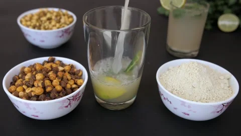 Summer drink Sattu with a slice of lemon, Dhania, and chili pouring in a glass Video stock 155824844
