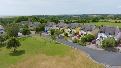 Summer Drone Flyover of St James Wood Thatched Cottages and Central Green Stock Footage 347959757