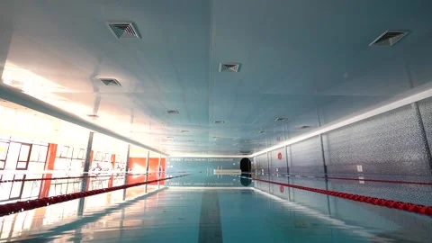 In summer, an empty indoor pool with clear water steadicam shot Stock Footage 201594161