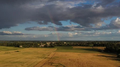 Summer end rainbow over ripe crop fields, aerial Stock Footage 119353318