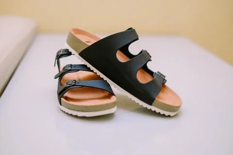 Summer essentials two stylish black buckle sandals on a clean surface Stock Photos