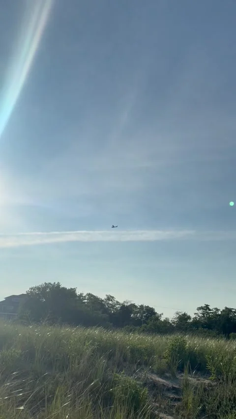 Summer Evening at Estuary Tracking a small aircraft in the distance Stock Footage 339090604