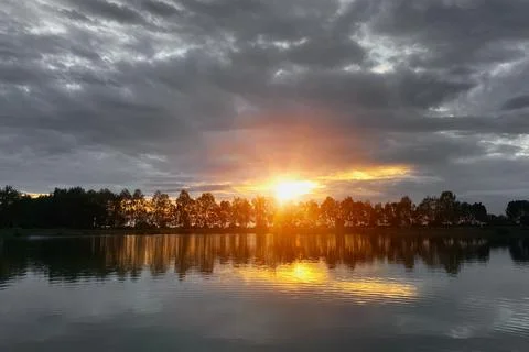 Summer evening landscape on the river, sunset near the water Stock Photos