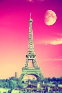Summer evening moon over the Eiffel Tower symbol of Paris Fotos Stock