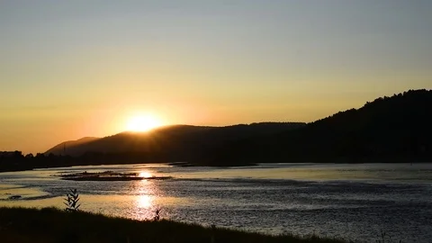 Summer evening on the river with the rays of the setting sun Stock Footage 119802036