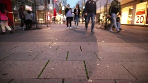 Summer evening with shops lighting up the streets in the background busy street Stock Footage 232667732