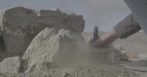 Summer, excavations, man clearing surface with brush, dust, dry earth, stones Stock Footage 308911944