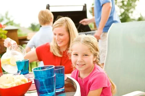 Summer: family having dinner on deck Stock Photos