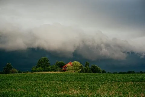 Summer field and dramatic sky before storm. Dark ominous clouds. Stock Photos