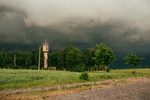Summer field and dramatic sky before storm. Dark ominous clouds. Stock Photos