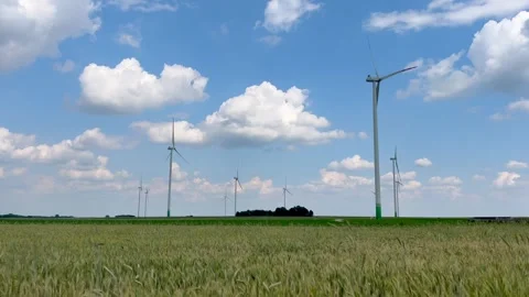 Summer fields under blue clouds. Windmills on field. Stock Footage 244240530