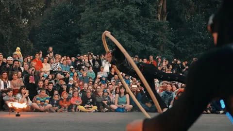Summer Fire show in the open air, the girl rotates inside a wooden ring. Stock Footage 160759635