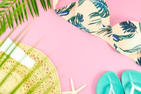 Summer flat lay beach concept. Top view bikini, hat and beach slippers. Flat lay Stock Photos