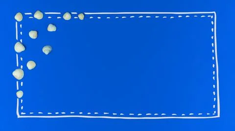 Summer flat lay border composition with seashell on a blue background, concep Stock Photos