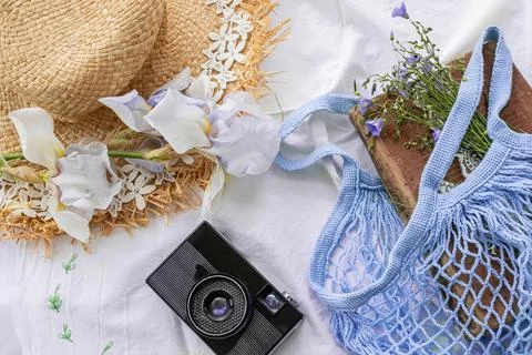 Summer flat lay. Eco-friendly mesh bag with vintage book and linen bouquet on Stock Photos