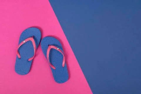 Summer flat lay with flip flops on a pink and blue background with space for  Stock Photos