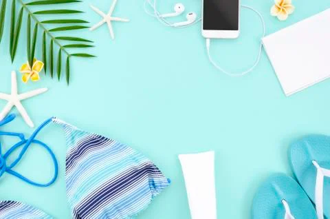 Summer flat lay frame with blue background. Lady's trip concept. Top view bikini Stock Photos