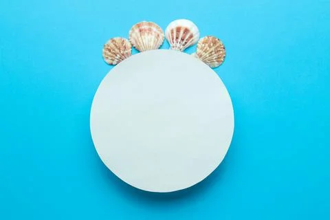 Summer frame. Paper frame for your text and seashells on a gentle blue backgr Stock Photos