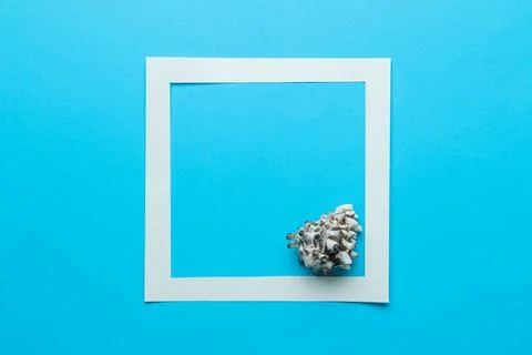 Summer frame. Paper frame for your text and seashells on a gentle blue backgr Stock Photos