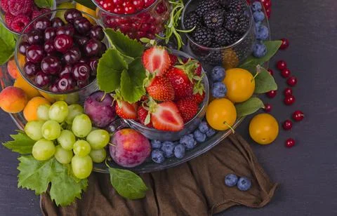 Summer fresh berries of different types on a black background Stock Photos