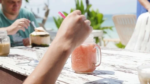 Summer fruit cocktail on the beach. Two friends are drinking cocktails in a cafe Stock-Footage 127150324