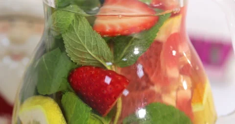 Summer fruit lemonade cooking, jug with drink Stock Footage 145560749