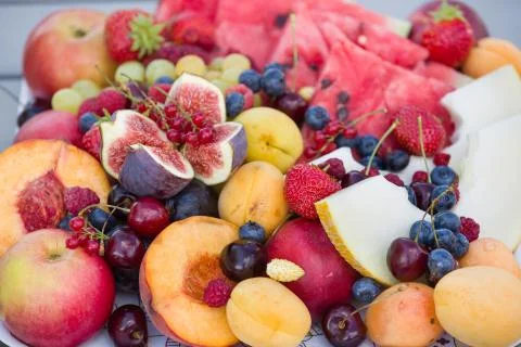 Summer fruit: Melon, peach, strawberries, blueberries, apples, figs, cherries Stock Photos