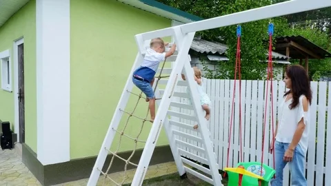 Summer, in the garden, children, a four year old boy and a one-year-old girl Stock Footage 80438860