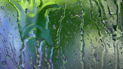 Summer garden defocused view through rainy window close up. Stock Footage 98679628