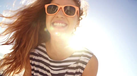 Summer girl laughing at camera on the beach in slow motion Stock Footage