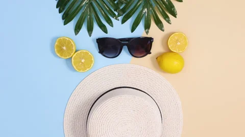 Summer hat and sunglasses move with lemons and tropic leaves Video stock 151934853
