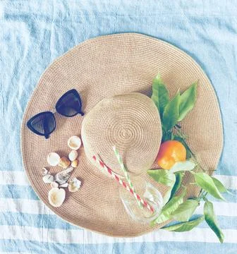 Summer hat on the beach towel Stock Photos