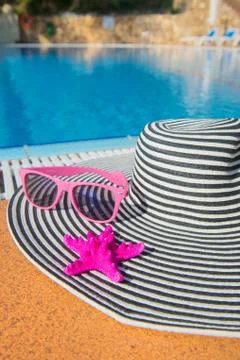 Summer hat at the swimming pool Stock Photos