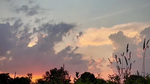 Summer heat clouds over a quiet prairie landscape at sunset Stock Footage 312023173
