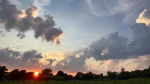 Summer heat clouds over a quiet prairie landscape at sunset Stock Footage 312023302