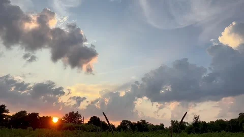 Summer heat clouds over a quiet prairie landscape at sunset Stock Footage 312023338