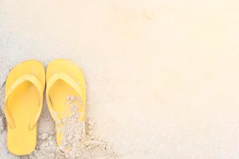 Summer holiday on the beach yellow sandals on the beach have sunset Stock Photos