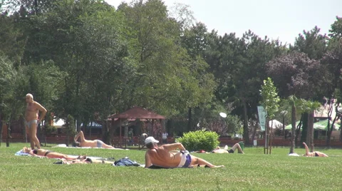 Summer holiday people getting some tan outdoor mountain tanning blacken the skin Stock Footage 40657892