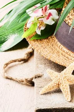 Summer holiday setting with straw hat Stock Photos