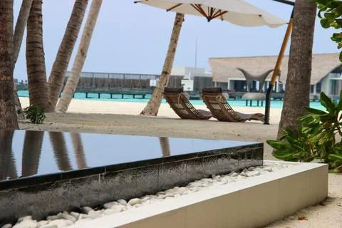 Summer image of a sun-bed on the beach in a resort Stock Photos