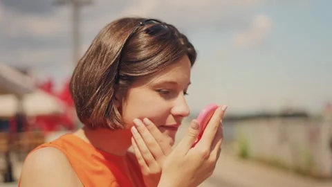 Summer joy and self-care: beautiful young woman checking herself in pocket Stock Footage 317168922