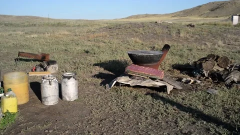 Summer kitchen in the field, cauldron, flasks. Video stock 139025707