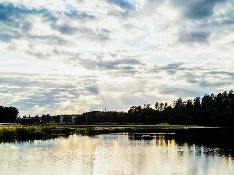 Summer landscape, blue sunset with clouds reflected in the river. Stock Photos