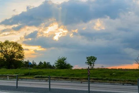 Summer landscape with dramatic sky on sunset Stock Photos