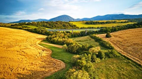 Summer landscape with fields, meadows and railroad bridge in mountains Stock Photos
