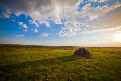 Summer landscape with a large haystack in the foreground Foto stock