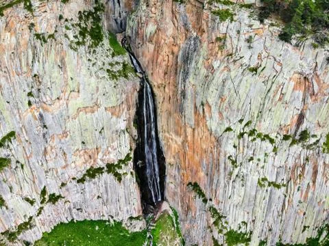 Summer landscape with mountain waterfall between two rocks taken by drone Stock Photos