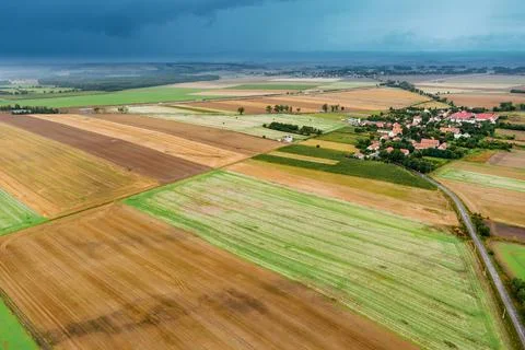 Summer landscape with a thundercloud over fields and forests, view from above Stock Photos