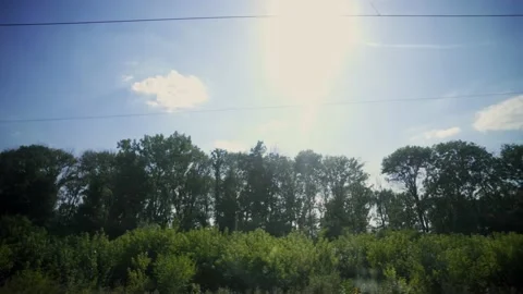 Summer landscape from the window of a speeding train. Fast-moving train. Trip. Stock Footage 152943193