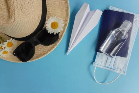 Summer layout with straw hat, daisies and sunglasses, airplane-origami, sanit Stock Photos